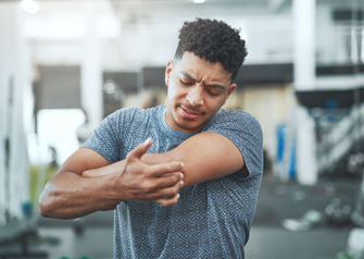Man touching elbow in pain