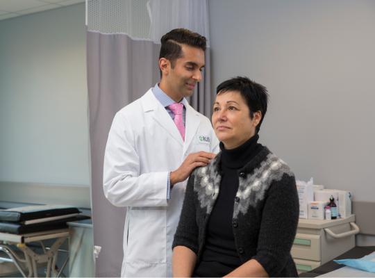 Dr. Kern Singh examining patient
