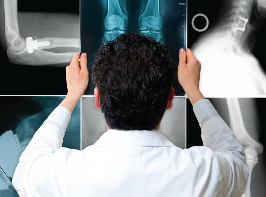 Dr. Adam Yanke Holding Up X-Ray Image