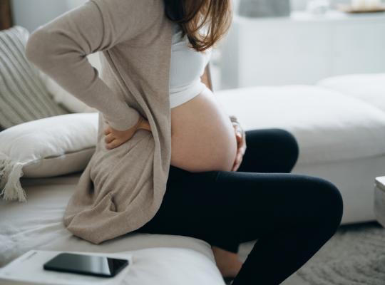 Pregnant woman dealing with back pain