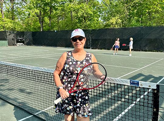 Patient Gina Quatrochi on tennis court
