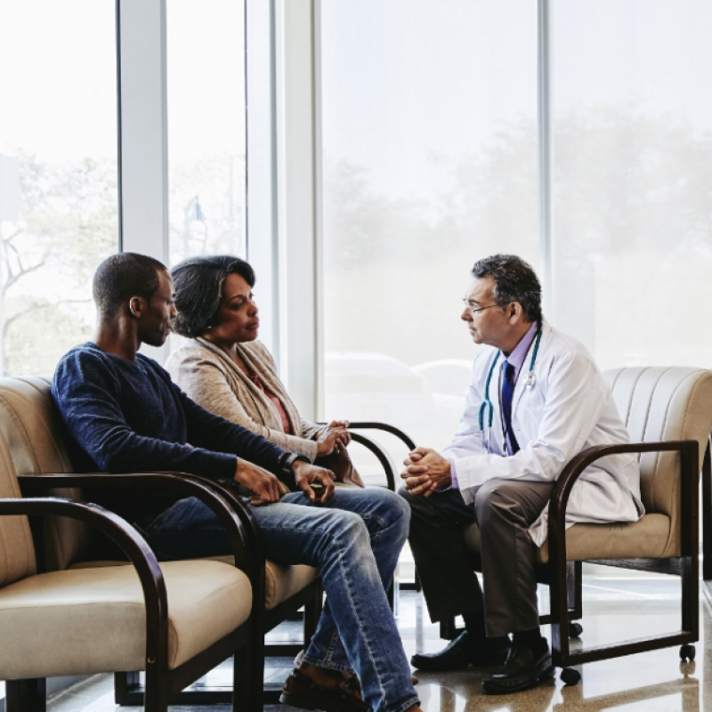 Couple sitting with a doctor